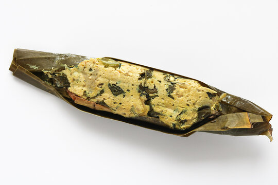 Pepes Tahu (Indonesian steamed or grilled tofu in banana leaves), the parcel is opened to reveal the savory, silken tofu mashed with aromatic spices.
