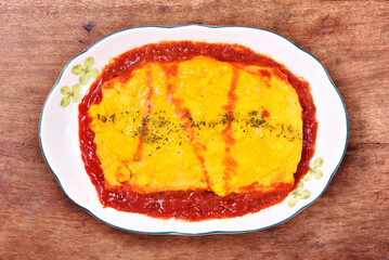 Japanese omelet rice on white plate.