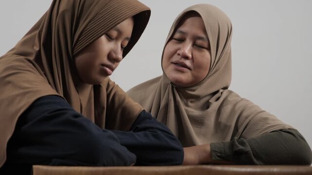 Mother talking closely to her daughter, deep conversation while sharing stories