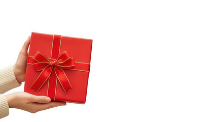 Hand holding red gift box with golden ribbon