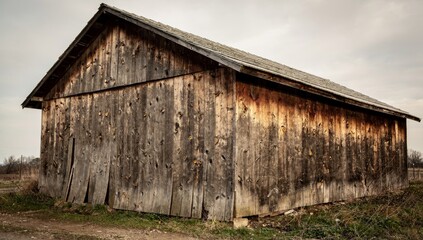 Fototapeta premium Old abandoned, red barn. Fading paint, dirty walls.