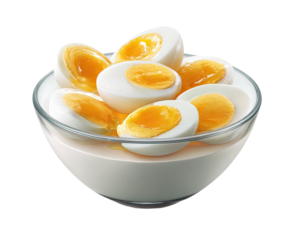 Boiled egg halves in clear bowl. Creamy white sauce surrounds. Close up