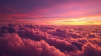 A breathtaking sunset view from above the clouds, showcasing vibrant hues of pink, purple, and orange blending seamlessly across the sky.