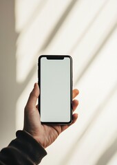 Hand Holding Smartphone with Blank Screen and Soft Shadow Background