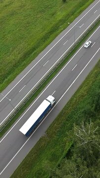 Vertical Screen Aerial View Mixed Traffic With Freight Truck And Van On Highway Beside Green Fields, Logistics Convoy Moving Along Lanes, Cargo And Shipment Flow, Depot And Fleet Context,
