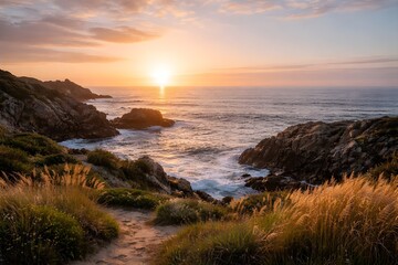 Golden hour sunset lights a rugged coastline, with warm reflections on ocean waters and windswept grasses along a scenic path, highlighting nature's serene beauty