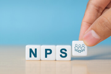 Net Promoter Score (NPS) measuring customer satisfaction and loyalty concept.Tool for measure customer loyalty and improvement products or services. White dice with NPS text and icon.