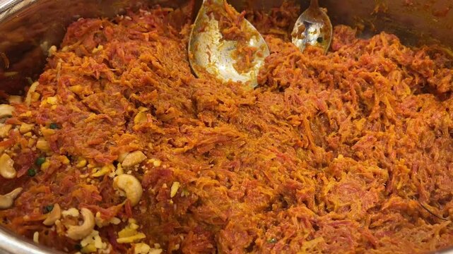 Gajar ka halwa prepared with dry fruits in an Indian wedding 