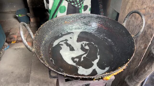 Fresh dal puri being cooked in hot oil in a roadside shop in India