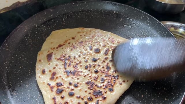 Bihari-style wheat Paratha is being freshly cooked in India