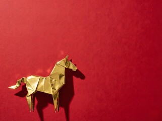 Elegant Golden Origami Horse on Red Background