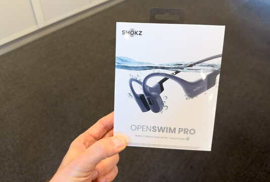 Shokz OpenSwim Pro Bone Conduction Headphones Retail Box Held In Hand