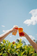 Hands Holding Pint Of Beer To The Sky © Claire