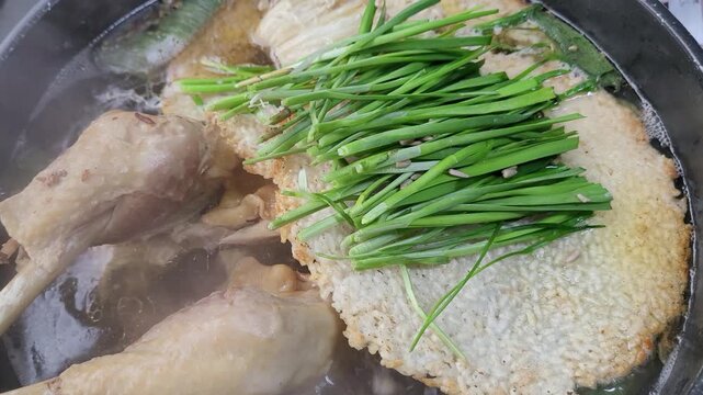 Korean Traditional Health Food Nurungji Baeksuk, Boiled Chicken with Scorched Rice Sizzling in a Pot