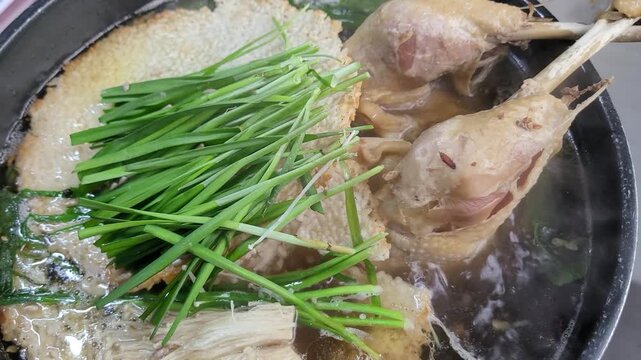 Korean Traditional Health Food Nurungji Baeksuk, Boiled Chicken with Scorched Rice Sizzling in a Pot