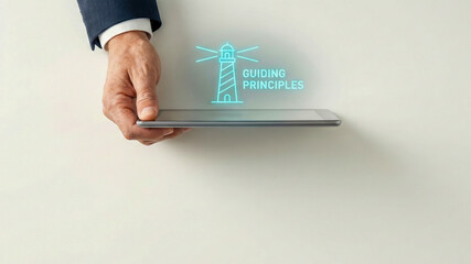 Financial high level planning concept guiding principles lighthouse icon over tablet in male hand modern business metaphor