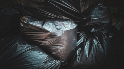 Black Garbage Bags Piled Together in Outdoor Area, Household Waste Collection and Urban Disposal Concept
