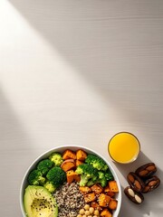 Nutritious vegan Buddha bowl accompanied by orange juice and dates