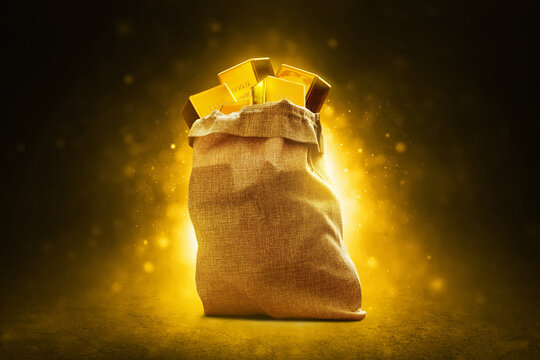 Stack of shiny gold bars in sack with glowing magic glitter sparkle effect on dark background