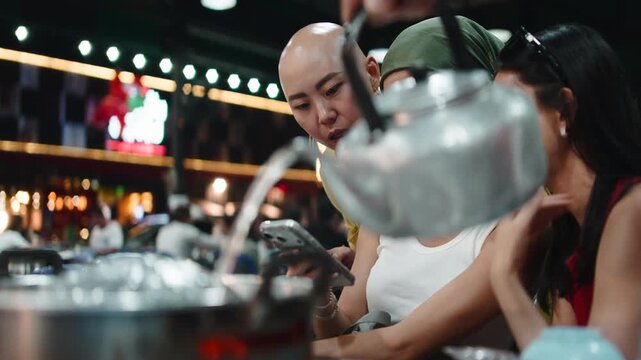 Asian friends dining at a thai bbq restaurant