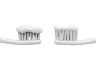 Two white toothbrushes loaded with paste, viewed from above, on black