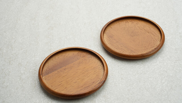 Round shaped wood coaster on a white background.