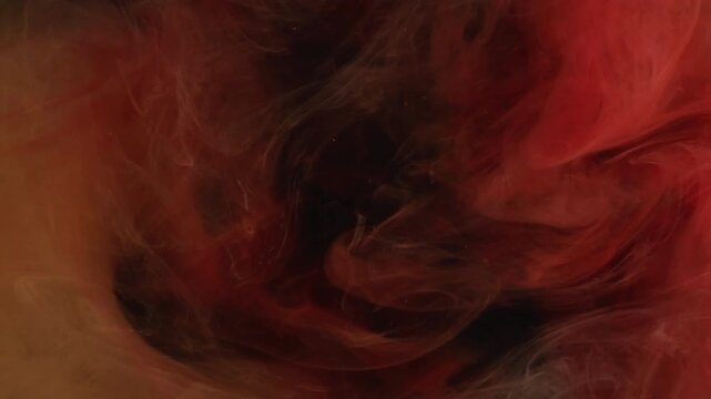Mix color. Flowing paint. Blur pink smoke ethereal vapor water wave chemical liquid floating on abstract dark black acrylic background.