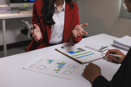 Business professionals discussing financial data analyzing charts - Powered by Adobe