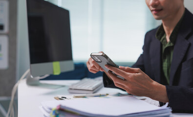 Business professional using smartphone connecting with colleagues