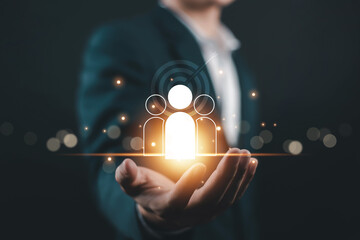 Business leader holding glowing human icon symbolizing digital human resources, talent job management, leadership strategy, recruitment technology, teamwork, innovation, and future workforce concept.