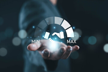 Business partnership and customer satisfaction concept with glowing digital handshake icon and min to max scale above human hand. Symbol of trust, service quality, collaboration, and value growth.