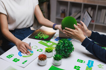 People discussing esg strategy holding green earth sphere