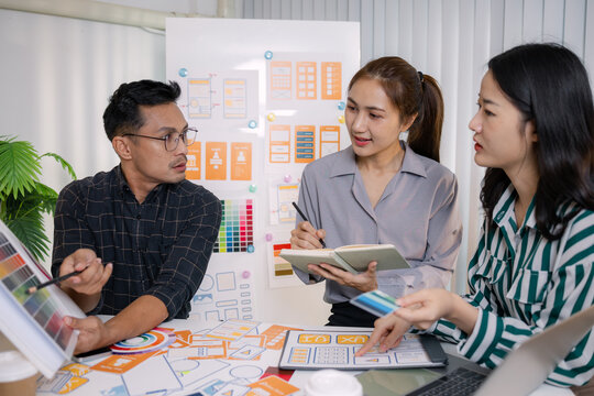 UX/UI designers presenting their final design project to the team, showcasing app interface screens and explaining user experience strategies in a professional creative office environment. - Powered by Adobe
