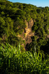 Stunning cliff formation in a lush green valley in Sao Paulo state. A landmark representing the region unique geology, farm pastures and the beauty of the Atlantic Forest biome