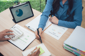 Business Meeting: Professionals collaboratively analyze financial reports, employing technology to strategize and make informed decisions, showcasing a modern and efficient approach to work.