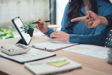 Business Discussion on Table: Focus on an intimate discussion, a pair of professionals meticulously dissecting data and charts, symbolizing teamwork, planning, and achieving ambitious goals. 