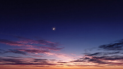 A stunning twilight sky with a crescent moon above the horizon