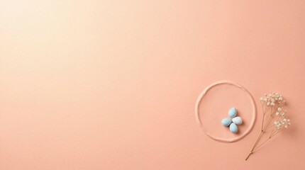 Pastel colored background with blue eggs in a circle and white flowers on the side for easter or spring themed designs and greeting cards with soft peach tones