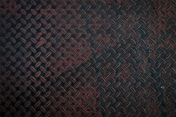 Close up textured iron metal surface with black tones and rust highlights creating a strong and striking background.