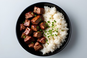 teriyaki steak bites in a black bowl served with white jasmine rice
