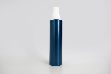 Mockup of dark blue plastic spray bottle for cosmetics isolated on grey background