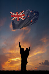 Father with son and the flag of New Zeland for national independence day