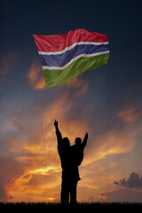 Father with son and the flag of Gambia for national independence day