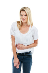 Fototapeta premium Portrait, woman and uncomfortable in studio with stomach ache from indigestion, unhealthy gut or diet. Upset, person and abdominal pain from IBS, bloating problem or constipation on white background.