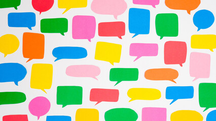 Pattern of multi-colored speech bubbles on a white background. Communication and social connections...