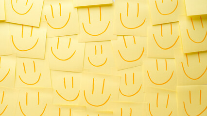 Background from yellow paper notes with smiling faces