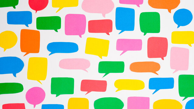 Pattern of multi-colored speech bubbles on a white background. Communication and social connections concept