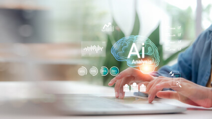 Man hand using laptop with AI Analysis digital brain hologram, showing big data processing and business intelligence technology icons for future innovation concept on blurred office background.