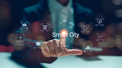 Businessman hand pointing at Smart City hologram interface with IoT icons, representing future urban technology, sustainable energy, and digital transformation in professional night background.