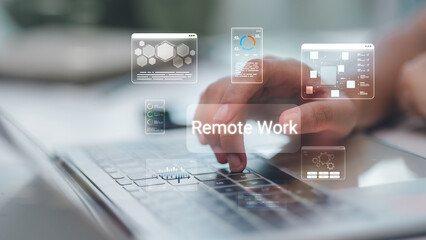 Close up of hand using laptop with Remote Work hologram interface, featuring data charts and business icons for digital nomad and flexible office concept in blurred background.